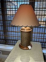 Full view of lamp on table showing base, shade, height