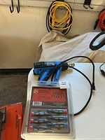 Overall lot showing screwdriver set, heat gun, two coiled extension cords