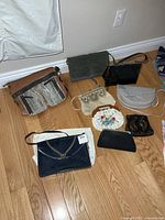 All nine purses laid out on floor