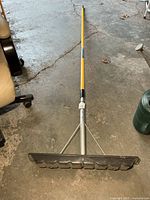 Full view of roof rake extended on floor