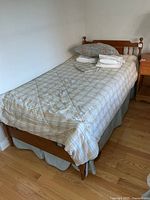 Bed assembled with bedding on, showing headboard