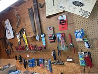 Overall pegboard with saws, screwdrivers, packaged bits