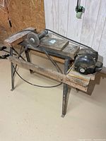 Full view of grinder, motor, belt drive and metal stand