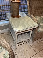 Side table front view showing glass top and lower shelf