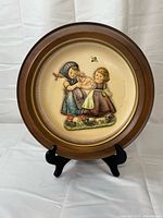 Full view of Goebel Hummel Happy Pastime plate on stand
