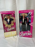 Front view of both boxed Barbie dolls