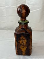 Full view of decanter front showing leather panels and shape