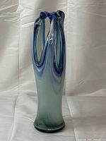 Full view of tall blue-green art glass vase