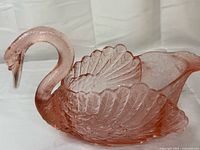 Left-front view of pink depression glass swan dish