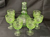 Full set view: decanter centered, six glasses surrounding