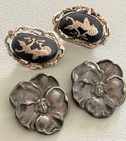 Group shot of two sterling brooches and two Siam niello earrings