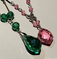 Close-up of green and pink teardrop pendants and bead detail