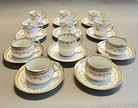 Front view showing all 11 cups and saucers