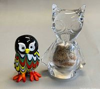 Front view of both owls showing colours, shapes and size comparison