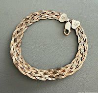 Full view of woven sterling silver bracelet laid flat in circle