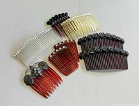 All seven hair combs laid out showing variety