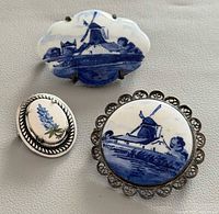 Group shot of three brooches showing overall design and scale