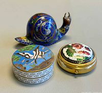 All three items: cloisonné snail, bird pill box, floral pill box