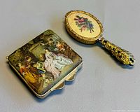 Handheld mirror compact with floral petit point and square powder compact with silk print side by side
