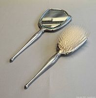 Front view of sterling handheld mirror and brush