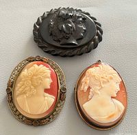 Front view of three cameos showing designs and frames