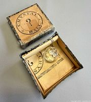 Box open showing die and folded instructions