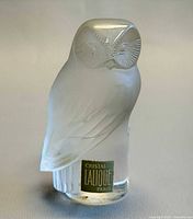 Full view of Lalique frosted crystal owl paperweight with label visible