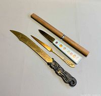 Three letter openers laid out showing sizes and styles