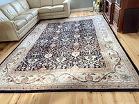 Full view of rectangular wool rug on hardwood floor