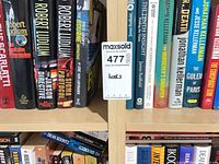 Shelf with Robert Ludlum, Jonathan Kellerman, Dean Koontz and other hardcover novels