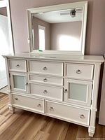 Front view of dresser showing drawers, cupboard doors, hardware, and attached mirror