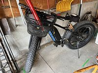 Side view of Greenway electric fat-tire bicycle showing frame, basket, pump, mirror, tires