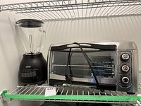 Oster blender and Hamilton Beach toaster oven on shelf