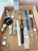 All fourteen watches laid out in a box