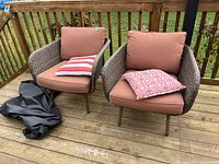 front view of both chairs with cushions, pillows, cover on deck