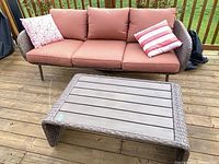 Front view of sofa with cushions and pillows alongside coffee table