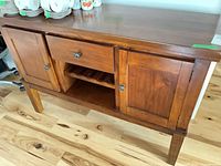 Front view of wood server showing drawer, wine rack, and cabinet doors