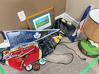 Group shot of pennant, banners, pucks, framed print and lamp