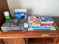 Overall view of Hitachi VCR, Sony DVD player, Coby box, DVDs stack, Philips cleaner