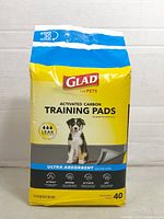 Front of sealed 40-count Glad Activated Carbon Training Pads package showing product name and size