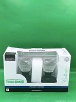 Front of sealed box showing crystal knobs and branding