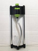 Front view showing full sprinkler with green control dial and metal spray bar