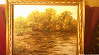 Front view of framed landscape painting