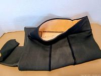 Black fleece-lined leggings folded to show tan interior fleece and waistband