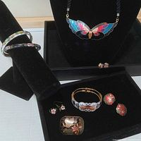 All jewelry displayed on stands showing necklace, bracelets, brooch and earrings