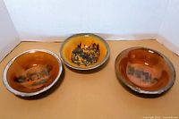 Three Ridgway bowls front view showing scenes and glaze