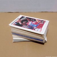 Stack of NBA Hoops era trading cards, Armon Gilliam card visible on top