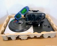 DJ Hero turntable, VR headset, XPAND glasses in molded tray