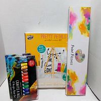 Front view of three boxed painting items: paint set, canvas kit, painting kit