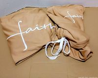 Shirt and shorts unfolded showing Faith print and drawstring